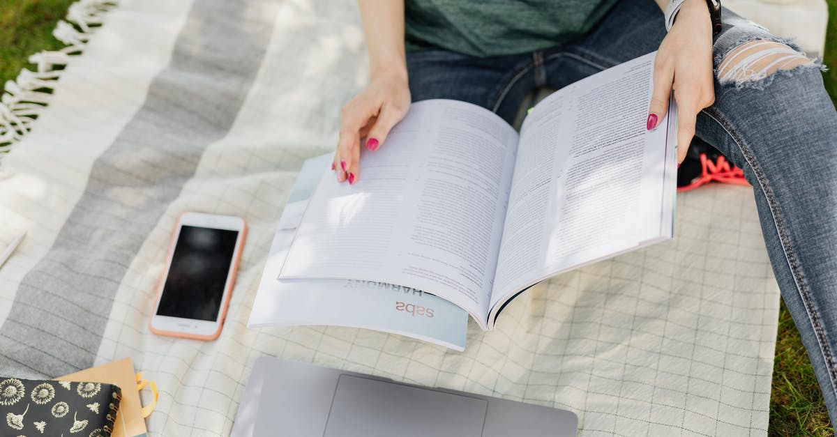 I am a graduate student traveling to France for a 5-day summer academic workshop at a university. Proof of accommodation? - Crop university student reading textbooks on green campus lawn