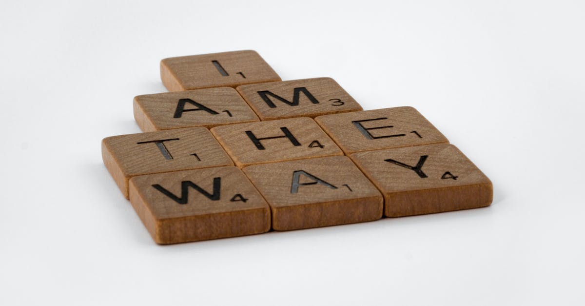 I am trying to find flight numbers and a booking reference - Brown Wooden Scrabble Pieces on White Surface