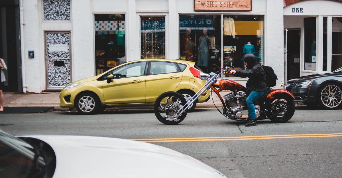 I have a cool suitcase. Might be tricky to ride a motorbike. Looking for a strap allowing to carrying it as a backpack? - Man riding chopper on asphalt road I have a cool suitcase. Might be tricky to ride a motorbike. Looking for a strap allowing to carrying it as a backpack? - Man riding chopper on asphalt road