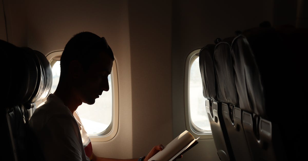 I was asked to transfer a book via airplane - A Man Reading a Book