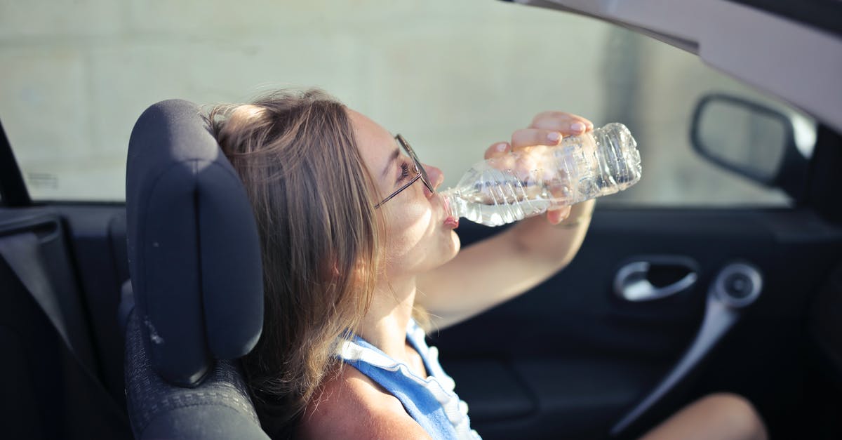 IATA rule regarding passenger right to drinking water [duplicate] - High angle side view of young woman in glasses and casual clothes drinking water from plastic transparent bottle while sitting in cabriolet with open roof in traffic jam in hot sunny day