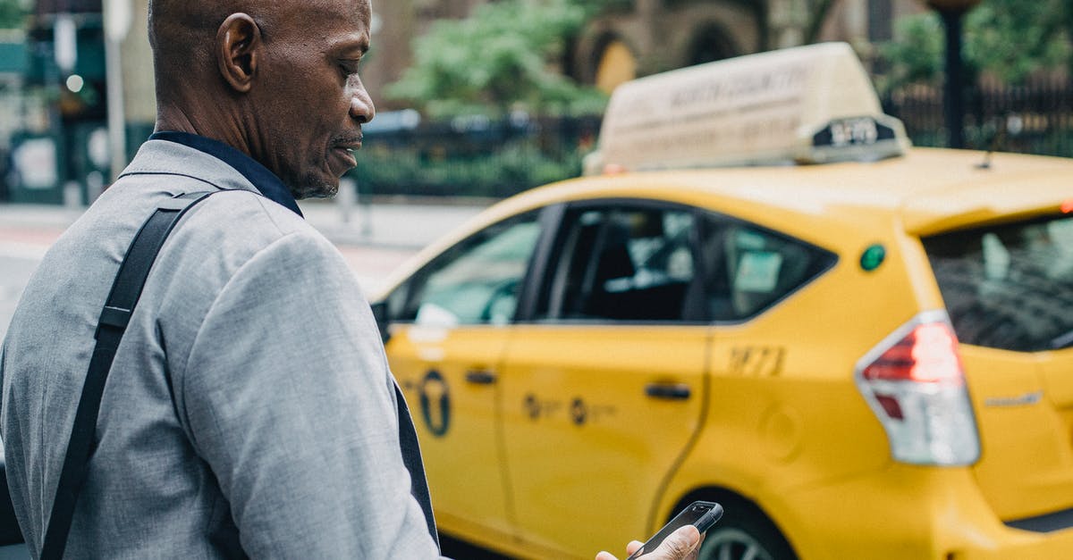 ID check crossing the Italian-Swiss border by car - Busy black businessman checking notification on smartphone while crossing street