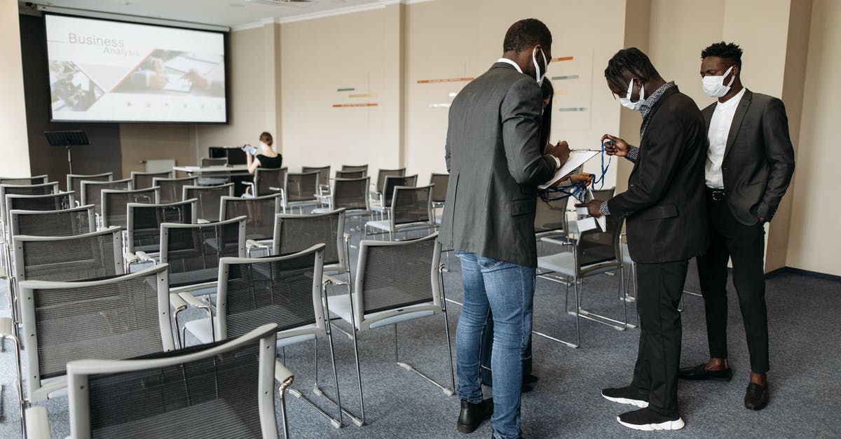 ID requirement on your person in the UK? - People inside a Conference Room Wearing Face Masks