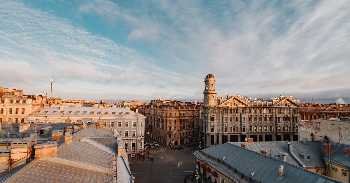 Identifying a community in Russia - Brown and White Concrete Buildings Under White Clouds