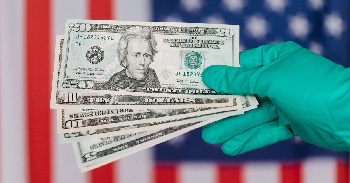 If I have an outstanding medical bill in America, can I go back there? [duplicate] - Banknotes of American dollars in hand against flag