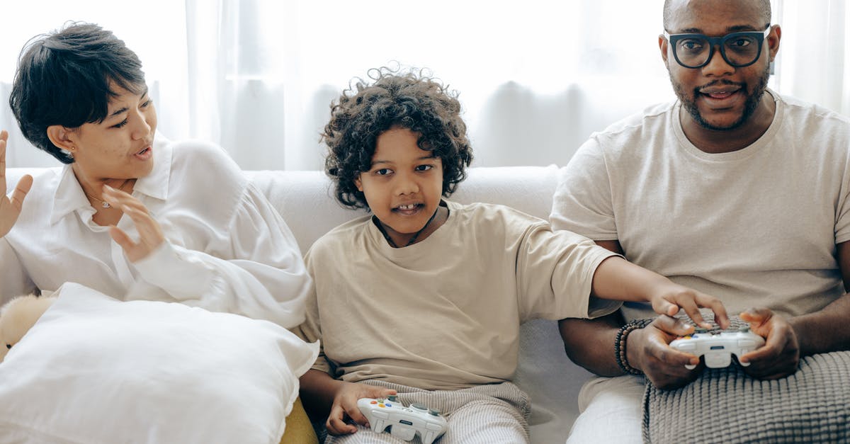 If I have to put up with bed bugs can I prevent bites or stop the itch? - Interested ethnic kid preventing father from winning in video game while resting together with mother in living room