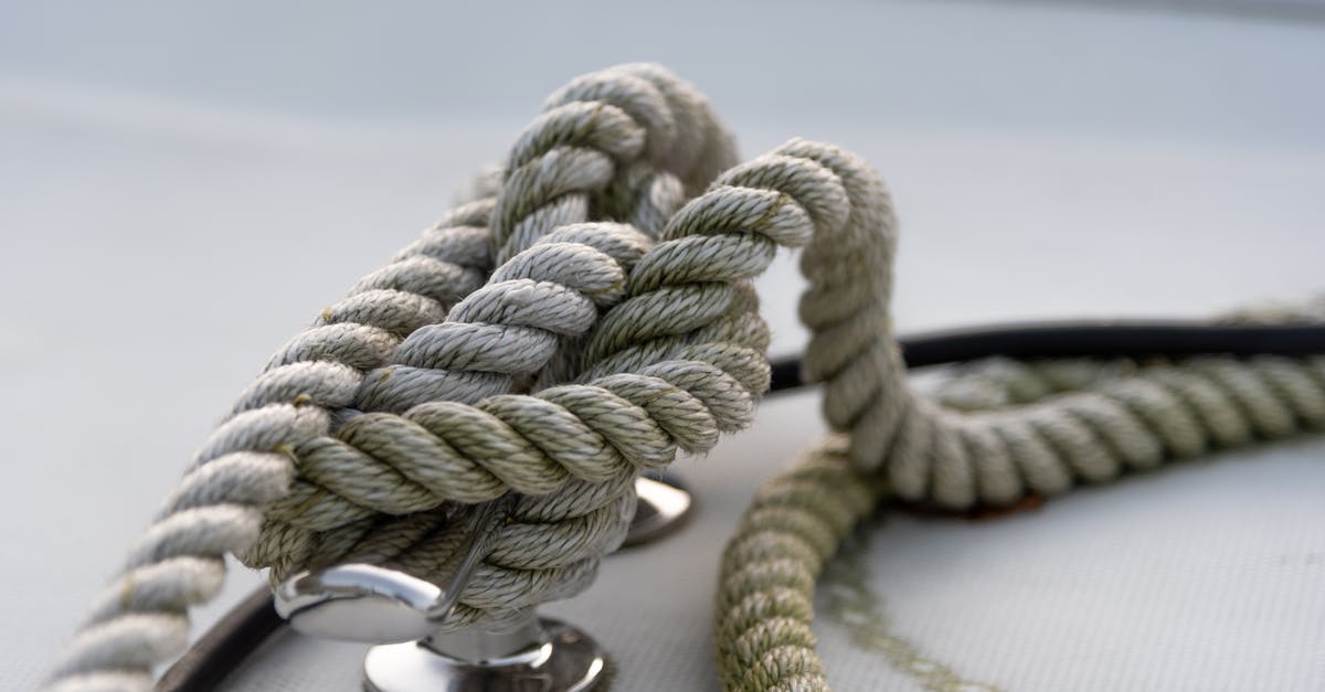 Immigration at Seattle sea port after Alaska cruise? [closed] - Closeup of strong mooring rope tied around steel anchor with nautical knot on modern yacht