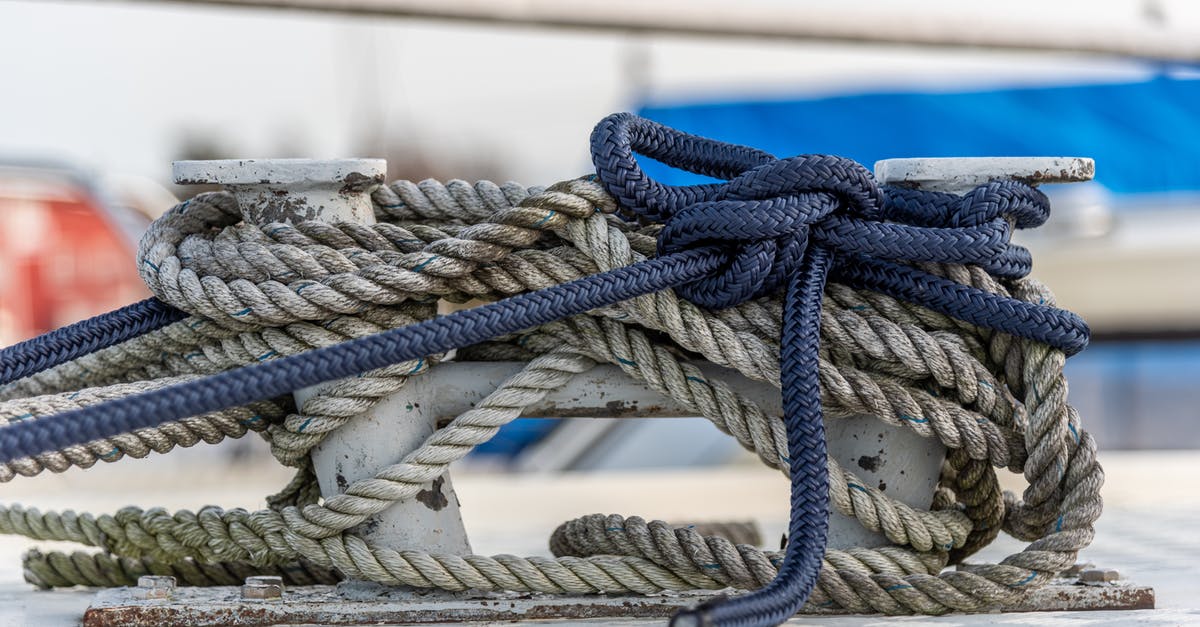 Immigration at Seattle sea port after Alaska cruise? [closed] - Close up of nautical knot ropes tied around metal bollard on modern ship deck