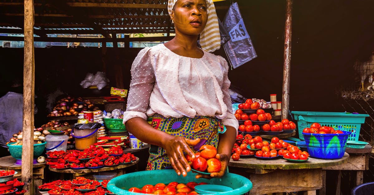 Immunizations needed for travel to South Africa - Woman Holding Tomatoes