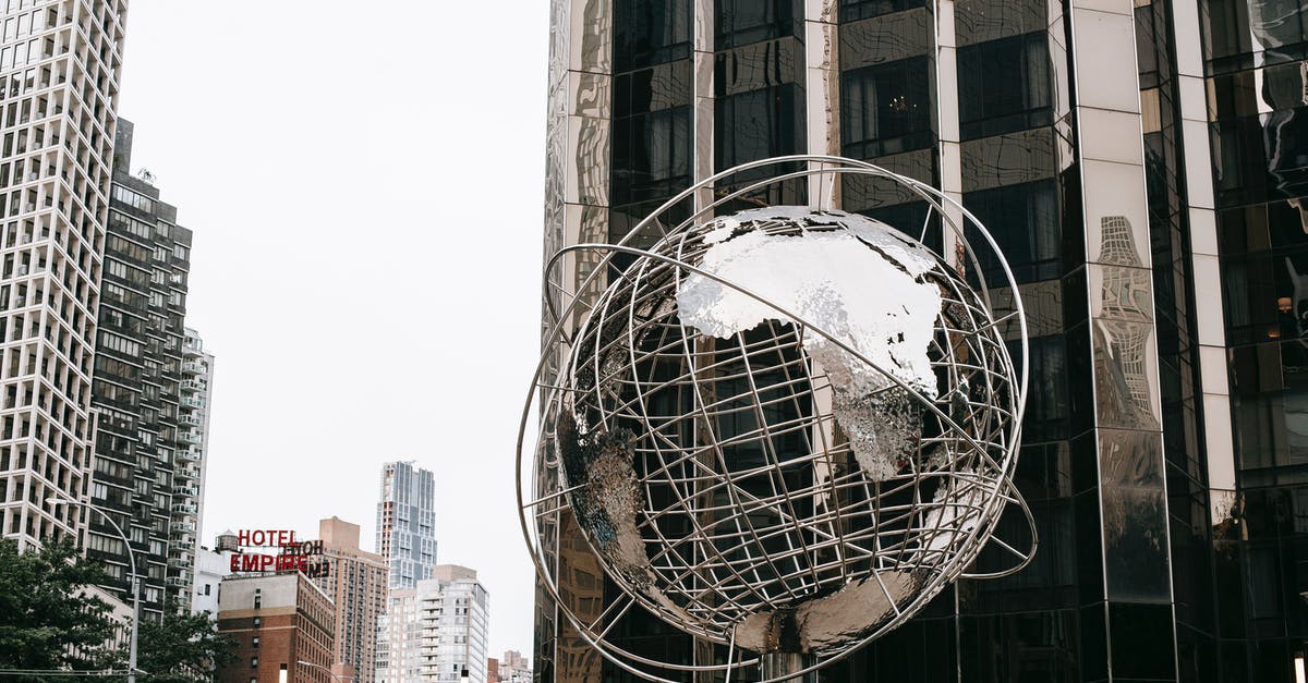 Importing Silver into the US - what duty will I pay? - Contemporary stainless steel unisphere sculpture located near modern skyscrapers against Trump tower on street in New York city on Manhattan