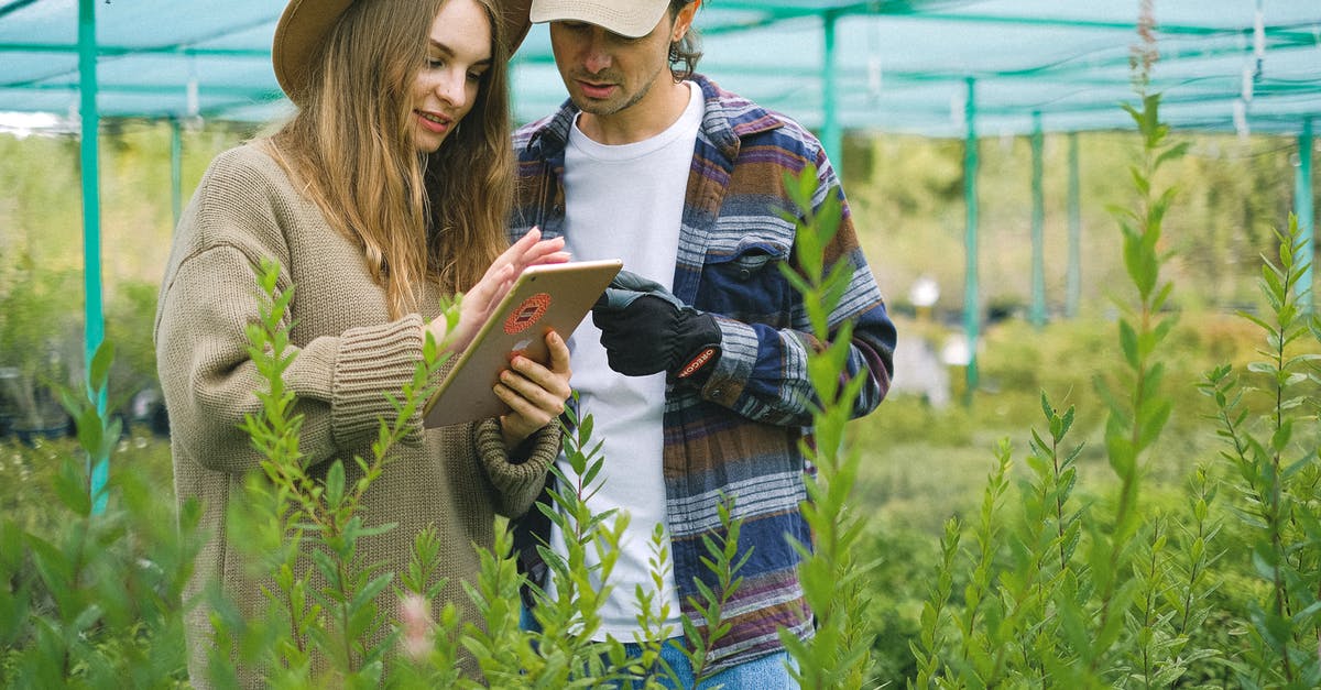 In an emergency, how do I find and share my position? - Focused couple searching information in farm