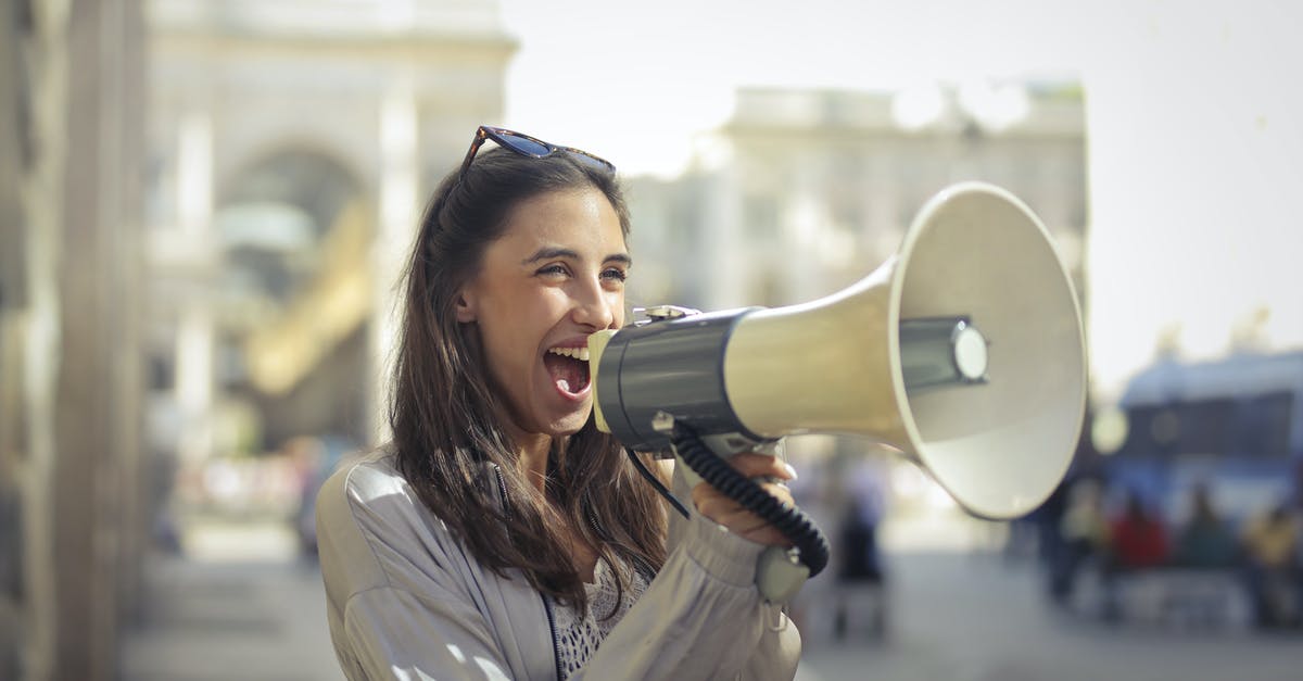 In an emergency, how do I find and share my position? - Cheerful young woman screaming into megaphone