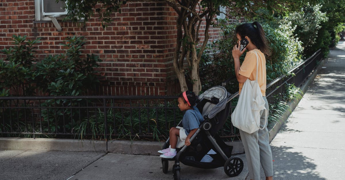 In Taiwan, what do you call those covered walkways? - Asian woman on street with daughter in baby stroller