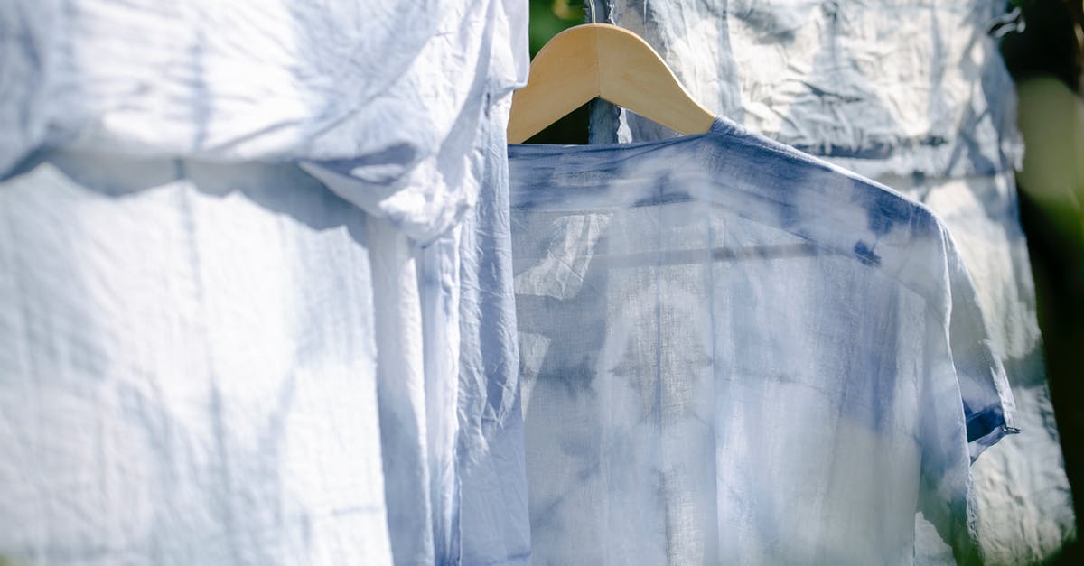 In the context of air travel, are layovers different to stopovers? - Collection of various washed clothes hanging on rope on fresh air on sunny day in summer