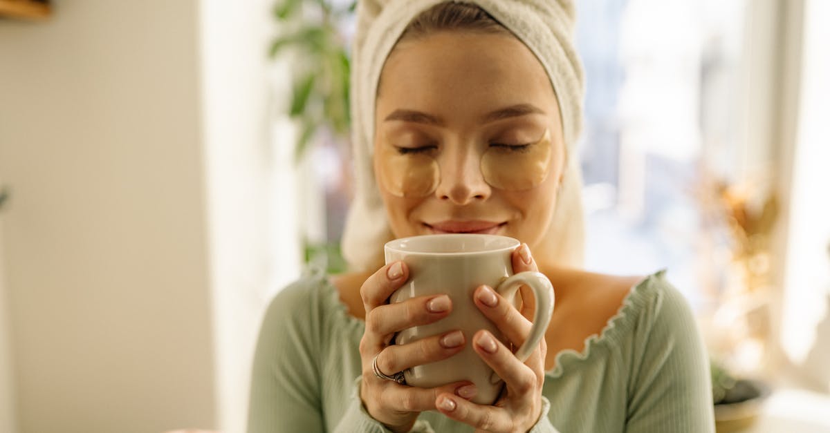 In what countries are tea towels available as souvenirs? [closed] - A Woman Holding a Cup with Eyes Closed