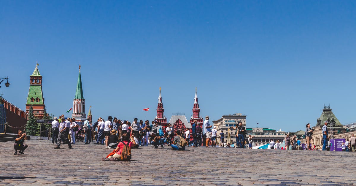 In which countries is Russian useful for anglophone tourists? - People Walking On A City Square Under Clear Blue Sky