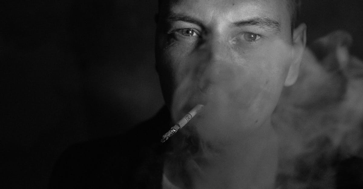 In which countries (or states) can a traveler smoke weed and not face any legal charges? [closed] - Grayscale Photo of a Man Smoking 