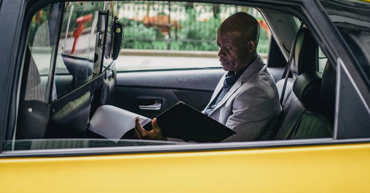 Independent contracting around the world - Pensive black entrepreneur examining important report in car