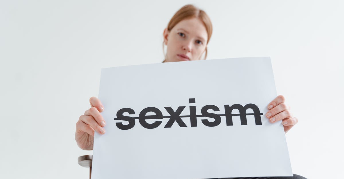 Independent contracting around the world - Woman Holding a Card with the Word Sexism