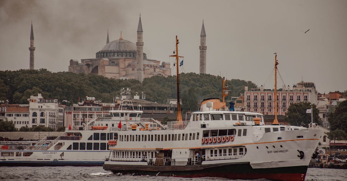 Independent excursions on Panama Canal cruise - Various vessels floating on Bosporus near ancient buildings and famous Church of Hagia Sophia against cloudy sky