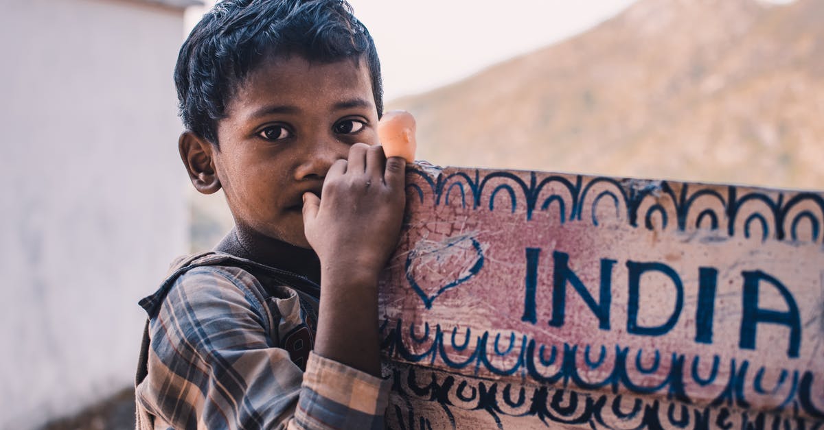 India - ID proof for child traveling on domestic flight - Close-Up Photography Of A Boy Near A Signboard