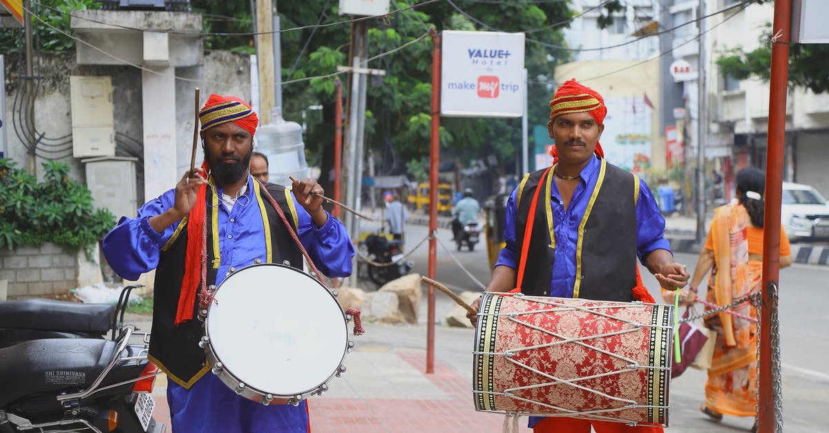 Indian National transiting through Helsinki [duplicate] - Man Holding Percussion Instrument