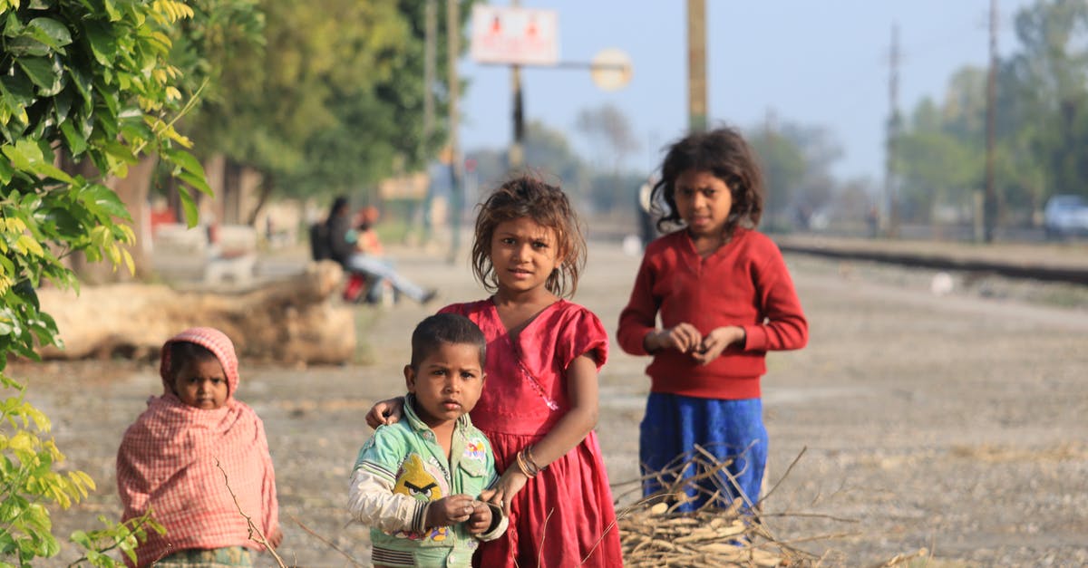 Indian passport with less than 6 months validity - Girl in Red Dress Holding a Girl in Pink Dress