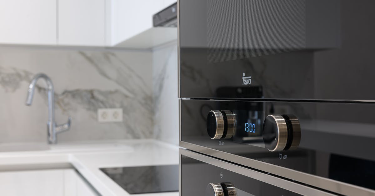 Induction stove in hand-luggage? - Interior of contemporary kitchen with stainless white surface induction cooker and electronic stove in modern apartment