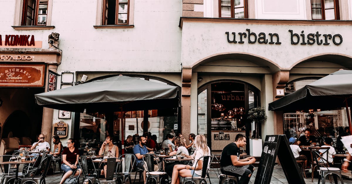 Inexpensive eating-out food in western Europe - Street cafe with people and tables