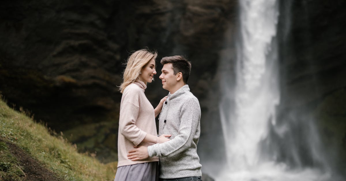 Information on visiting Iceland - tourism [closed] - Loving young couple embracing in canyon near waterfall