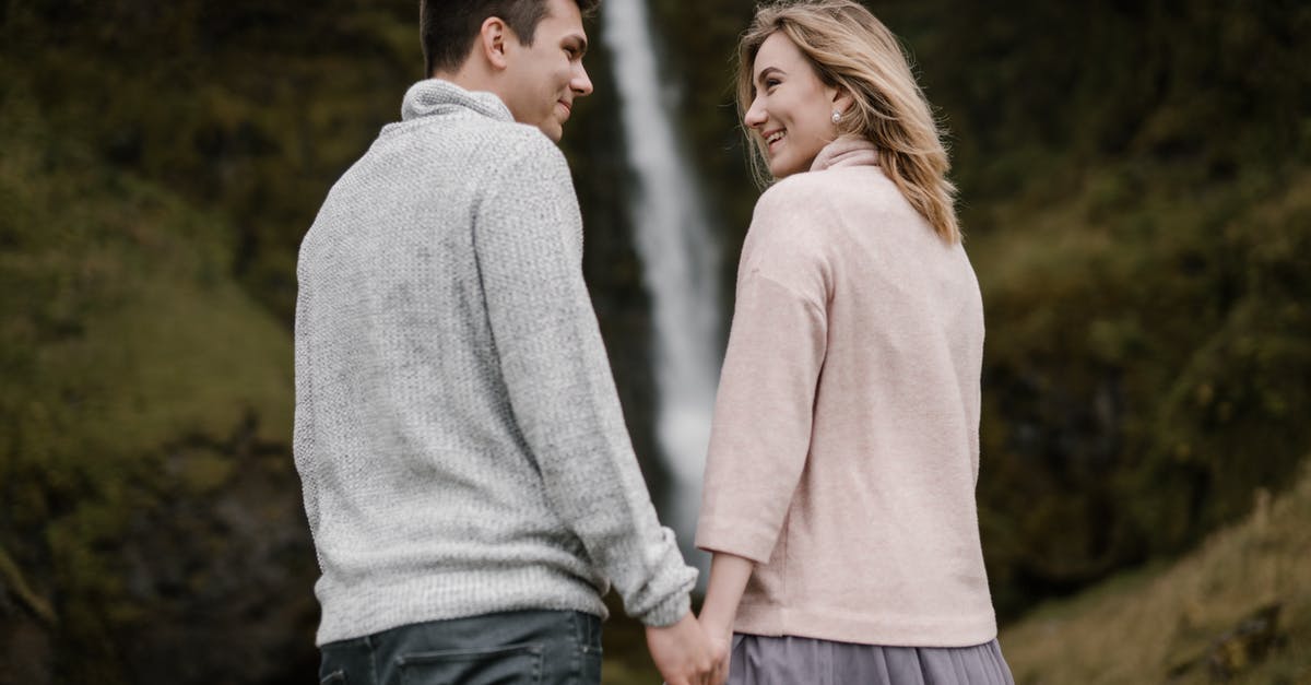 Information on visiting Iceland - tourism [closed] - Excited young couple smiling and enjoying view of waterfall