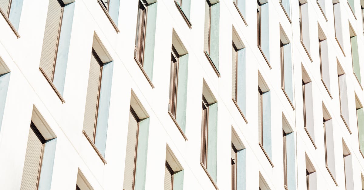 Infrastructure and accommodation in eastern Zambia - From below of lots of long narrow identical windows of contemporary construction in sunlight