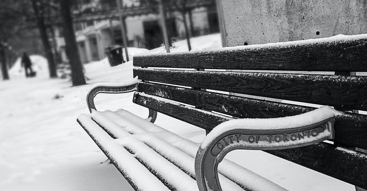 Insurance against flight cancellation due to weather in Canada [closed] - Monochrome Photography of Bench Covered with Snow