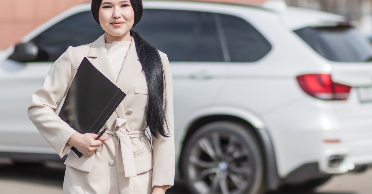 Insurance for car rental in Costa Rica - Woman in Beige Corporate Clothes Holding Black Folder 