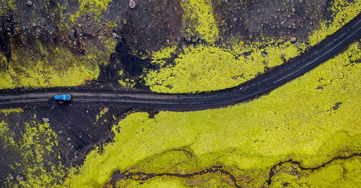 Insurance required while renting a car in Iceland [closed] - Aerial Photography of Blue Vehicle at Road