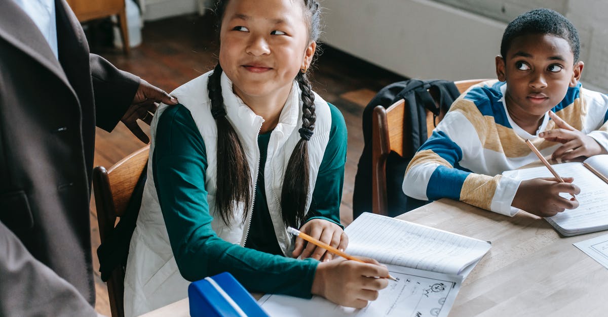 Interesting CTA Immigration Question [duplicate] - Crop black teacher talking with smart multiethnic boy and girl siting at desk with notepads