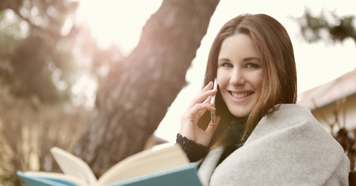 International calling and data connectivity - Woman in Gray Sweater Sitting Under the Three Trunks