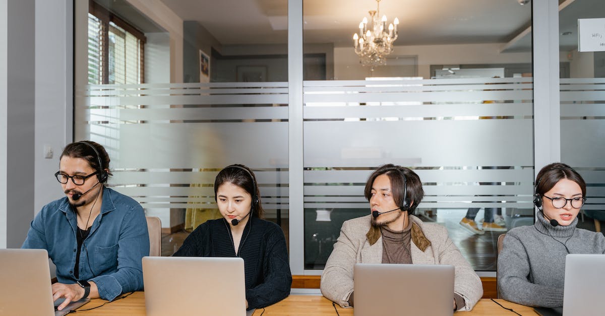 Internet Service for multiple people - Multiracial Employees Sitting in Front of Silver Laptops