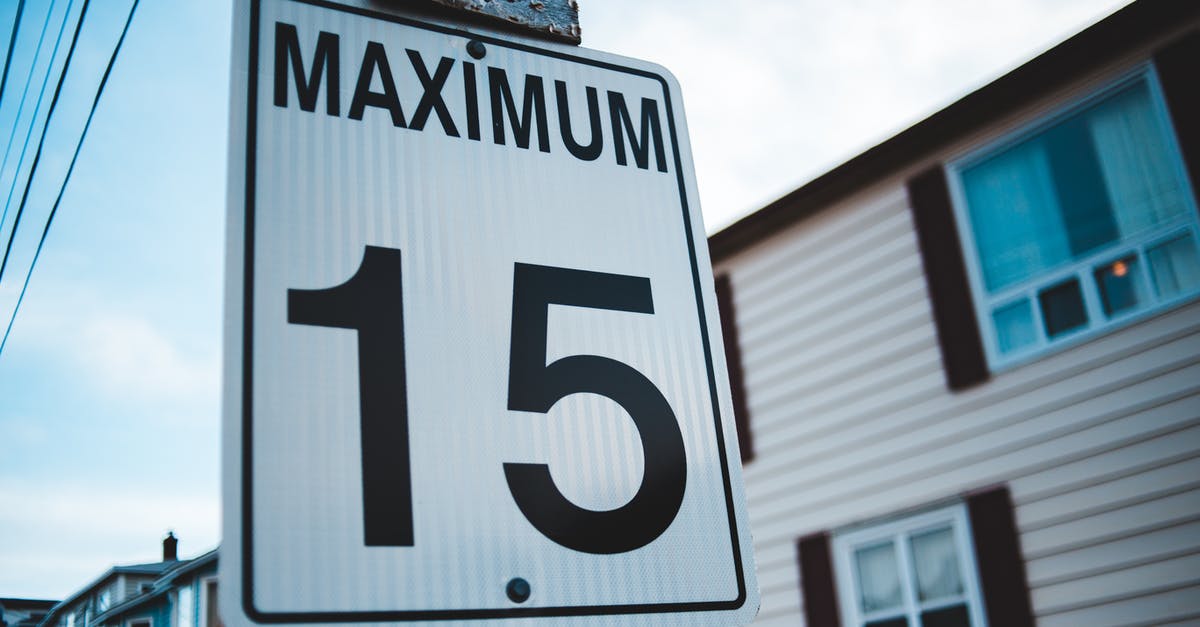 Inverted Speed Limit sign in South Korea - Regulatory road sign with Maximum inscription and number 15 against house facade in city in daytime