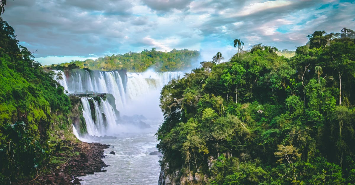 Iquitos or Puerto Maldonado, for jungle adventures in Peru? - Scenic Photo of Waterfalls Between Trees Under Cloudy Sky