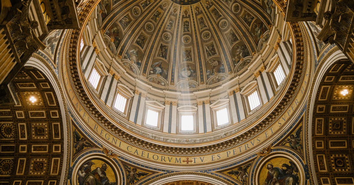 I’m Australian with a 5 year permission to stay from italy - Low angle impressive design of dome with fresco paintings and golden ornamental elements in famous Catholic Saint Peters Basilica in Rome