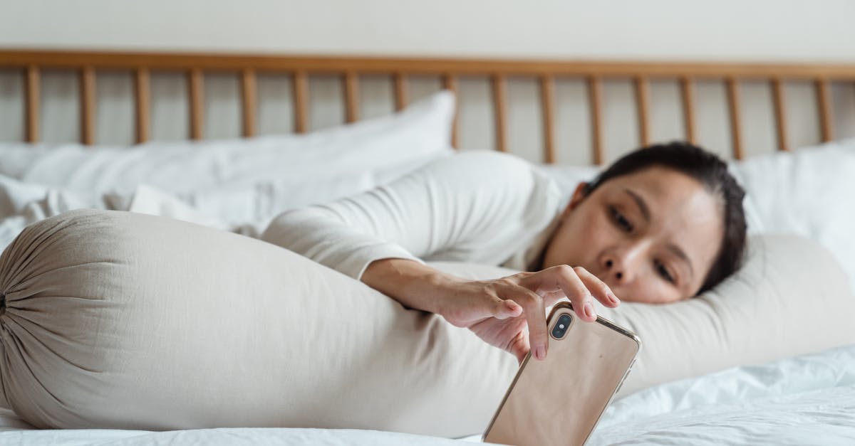 Is 12 minutes connection in Bristol Temple Meads long enough? - Content young ethnic female watching video on cellphone while lying on comfortable bed with long cylinder pillow in morning and enjoying free time