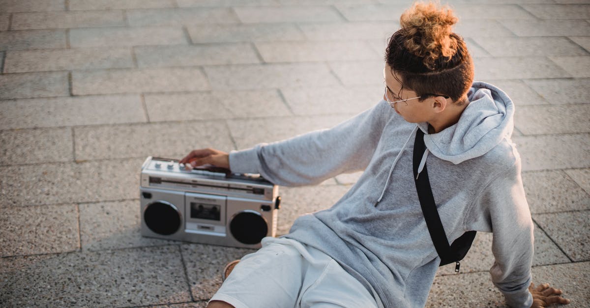 is 55 minutes enough time to connect in Guadalajara from Mexico City to Sacramento,Ca? - Trendy young ethnic guy listening to music with boombox on street