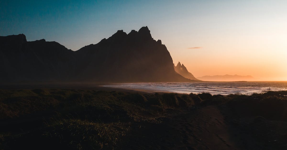 Is a 4x4 a must in Iceland in April/May? - Silhouette of Mountain Near Body of Water during Sunset