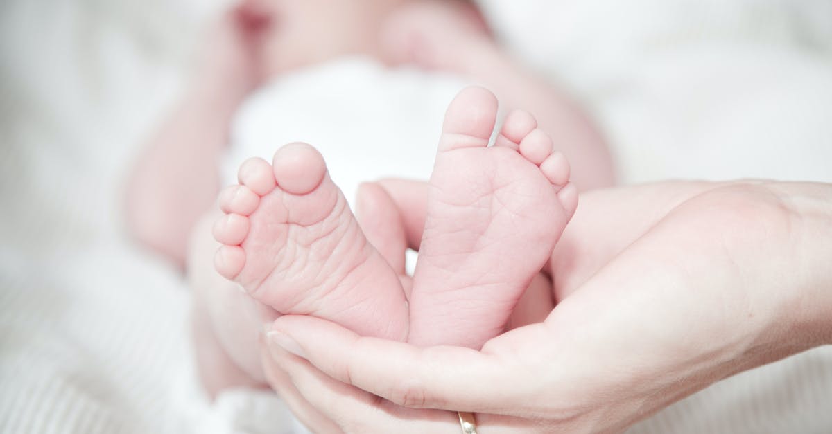 Is a birth certificate enough for a Nexus child application? - Close-up of Hands Holding Baby Feet