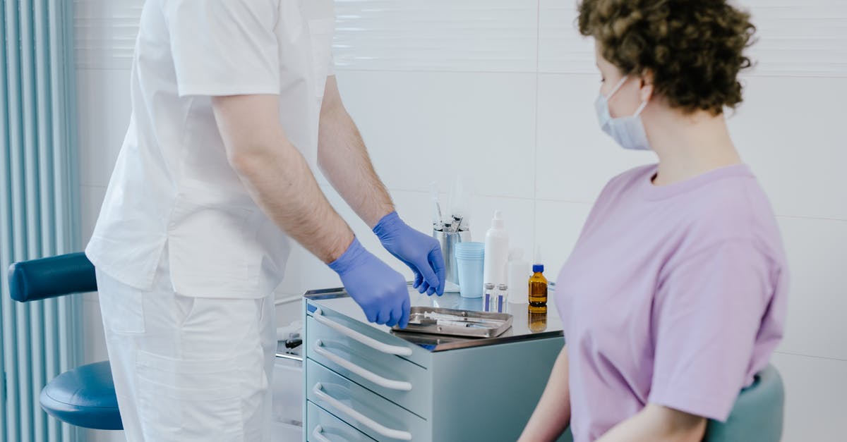 Is an E-ticket required to check-in? [closed] - Doctor doing an Examination to his Patient 