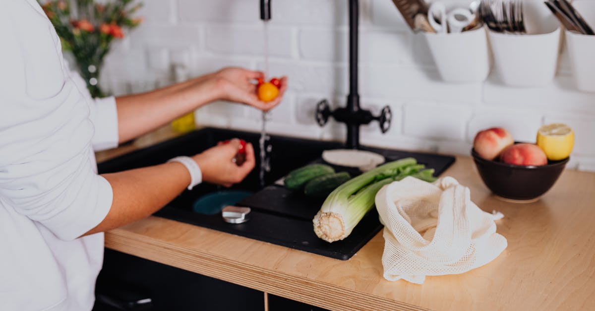 Is boiling tap water sufficient? - Woman Washing Fresh Ingredients under Tap Water in Kitchen