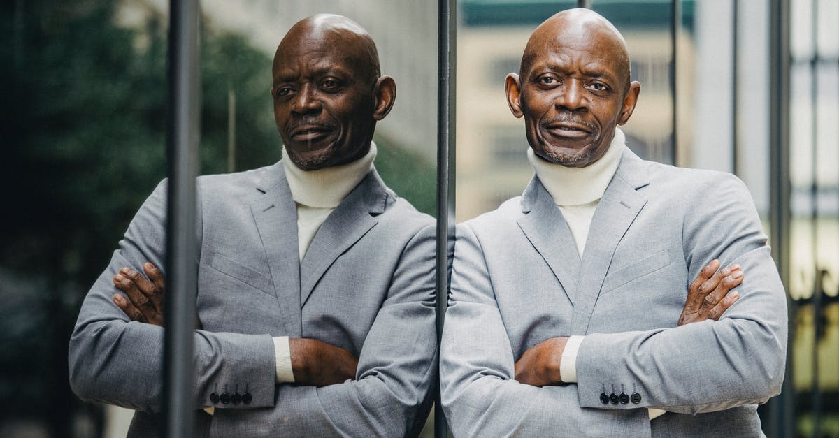 Is busticket4.me reliable? - Serious black businessman leaning on glass wall