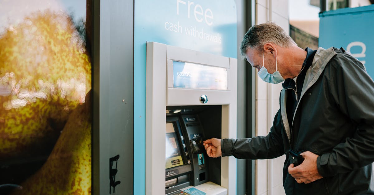 Is Chime a real bank for immigration purposes? - Man Using ATM Machine 