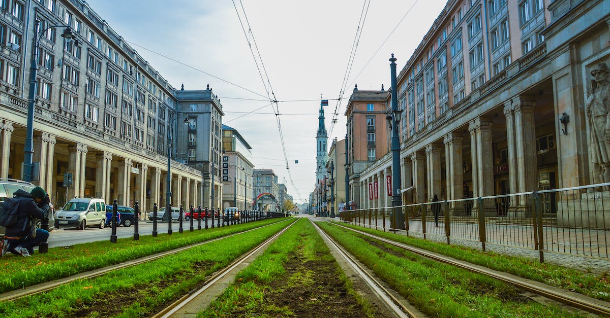 Is Colmar's railway station next to the city center? - Green Grass Between Concrete Buildings